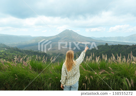 A person points at Mount Batur in Kintamani Bali A person points at Mount Batur in Kintamani Bali 138555272