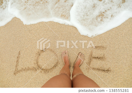 Writing love in the sand at a Bali beach while relaxing Writing love in the sand at a Bali beach while relaxing 138555281