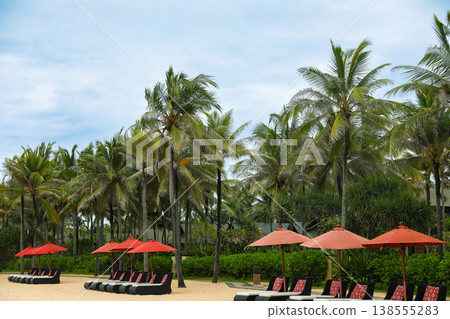 Beach chairs and umbrellas set up in Bali for visitors Beach chairs and umbrellas set up in Bali for visitors 138555283