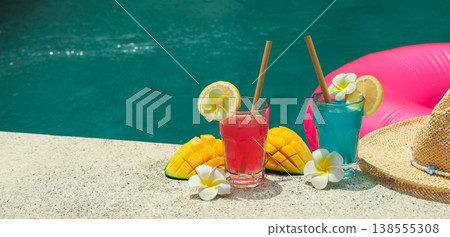 Refreshing drinks with mango slices and flowers by poolside 138555308