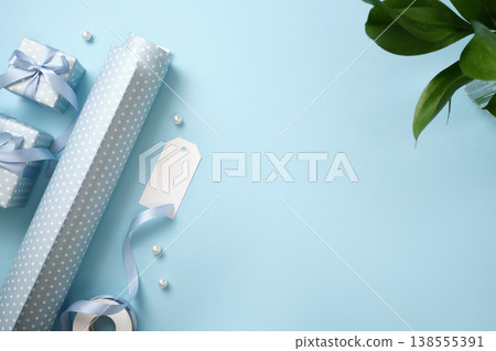Festive background with blue wrapping paper, a label, a ribbon and presents. Copy space Festive background with blue wrapping paper, a label, a ribbon and presents. Copy space 138555391