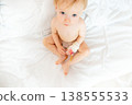 A small child in the hospital asks to be picked up by his mother 138555533