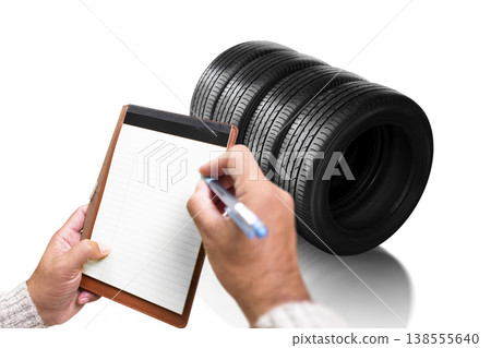 Tire Inventory Inspection, A person writes on a blank notepad while checking Tire Inventory Inspection, A person writes on a blank notepad while checking 138555640