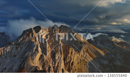Amazing rocky mountains in clouds at sunset 138555840