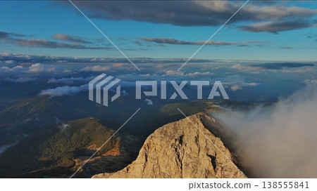 Amazing rocky mountains in clouds at sunset 138555841