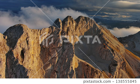Amazing rocky mountains in clouds at sunset 138555845