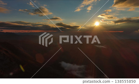 Amazing rocky mountains and sun at sunset Amazing rocky mountains and sun at sunset 138555850