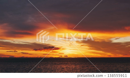 Sunset over sea with vibrant red and orange sky Sunset over sea with vibrant red and orange sky 138555911