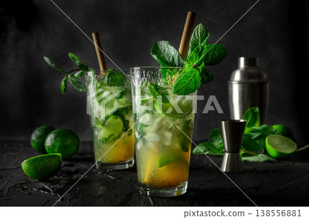 Mojito, summer cocktail with mint, lime, and ice, side view of two glasses Mojito, summer cocktail with mint, lime, and ice, side view of two glasses 138556881
