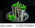 Mint Julep in the Kentucky Derby classic silver glass, with fresh mint leaves 138556884