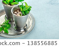 Mint Julep in the Kentucky Derby classic silver glass, with fresh mint leaves 138556885