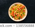 Chow Mein noodles with chicken and vegetables, overhead flat lay shot on black 138556888