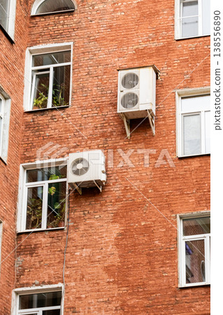 air conditioning on facade of building, air cooling in hot weather. air conditioning on facade of building, air cooling in hot weather. 138556890