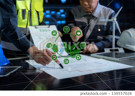 Environmental engineering team meeting with renewable energy model and ESG report in office. Environmental engineering team meeting with renewable energy model and ESG report in office. 138557026