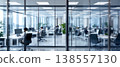 Photo of a modern office space with glass walls and people working at desks, creating a bright and collaborative work environment. 138557130