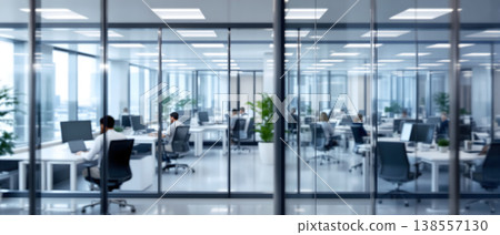 Photo of a modern office space with glass walls and people working at desks, creating a bright and collaborative work environment. Photo of a modern office space with glass walls and people working at desks, creating a bright and collaborative work environment. 138557130