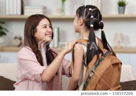 Parent helping child prepare for school 138557209