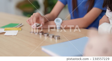 Child counting coins for financial education 138557229
