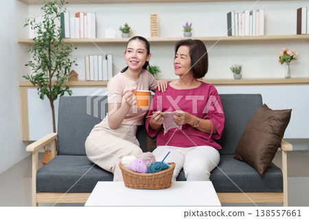 Mother and daughter bonding over knitting and tea 138557661