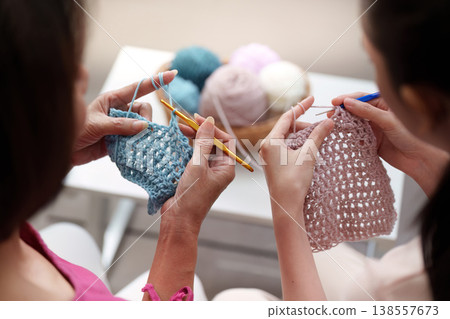 Mother and daughter knitting together on Mother's Day Mother and daughter knitting together on Mother's Day 138557673