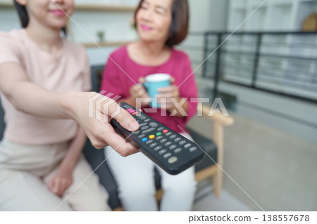 Mother and daughter enjoying TV time on Mother's Day Mother and daughter enjoying TV time on Mother's Day 138557678