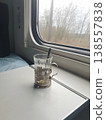 Glass Tea Cup in Metal Holder on Train Table by Window 138557838
