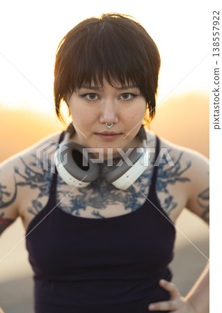 Confident tattooed young woman looking at camera Confident tattooed young woman looking at camera 138557922
