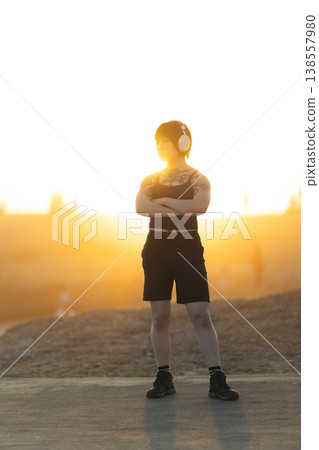 Athletic woman standing confident with arms crossed outdoors Athletic woman standing confident with arms crossed outdoors 138557980