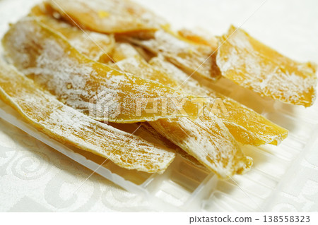 Delicious-looking dried sweet potatoes against a white background. Delicious-looking dried sweet potatoes against a white background. 138558323