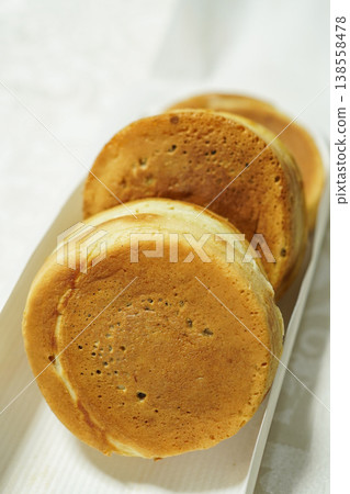 Close-up of Imagawayaki (large-sized pancake, round pancake) against a white background. 138558478