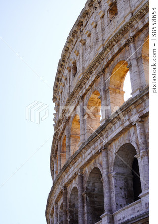 A vertical photo of the Colosseum, a landmark of Rome, on a clear, sunny day. A vertical photo of the Colosseum, a landmark of Rome, on a clear, sunny day. 138558653