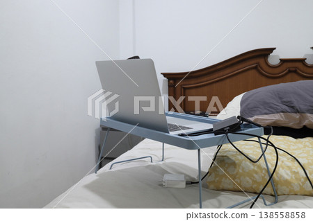 Laptop on a foldable lap desk Laptop on a foldable lap desk 138558858