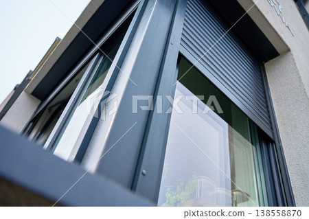 Corner of house with roller shutter on window Corner of house with roller shutter on window 138558870