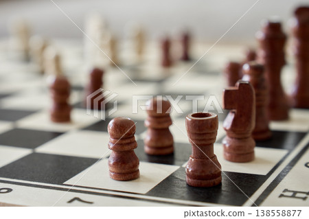 Close-up of wooden chess pieces on chessboard Close-up of wooden chess pieces on chessboard 138558877