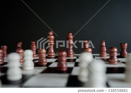 Wooden Chess Pieces on chessboard during game Wooden Chess Pieces on chessboard during game 138558881
