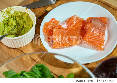 Healthy Breakfast Ingredients with Salmon, Avocado and Greens on Cutting Board 138558890