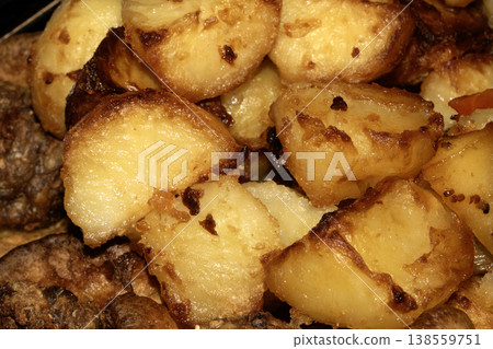 Close up of roasted vegetables crsipy potatoes side dish for Sunday roast dinner Close up of roasted vegetables crsipy potatoes side dish for Sunday roast dinner 138559751