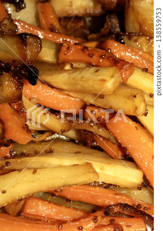 Close up of roasted vegetables honey and mustard parsnip and carrots side dish for Sunday roast dinner Close up of roasted vegetables honey and mustard parsnip and carrots side dish for Sunday roast dinner 138559753