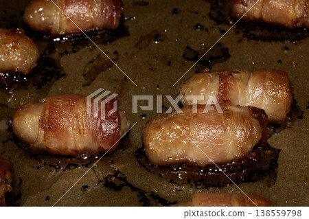 Close up of chipolatas pigs in blankets sausages wrapped in bacon on white background 138559798