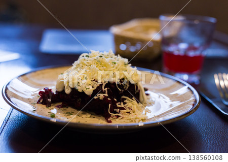 dish of beets, cheese, mayonnaise on a plate in restaurant dish of beets, cheese, mayonnaise on a plate in restaurant 138560108