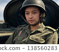 On the dusty front lines, a female soldier in camouflage uniform gazes intently from the hatch of a T-90M tank, alongside the imposing presence of its machine gun. 138560283