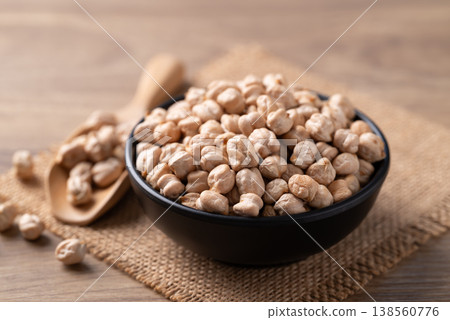 Organic raw chickpeas in a black bowl and scoop, healthy food ingredient 138560776