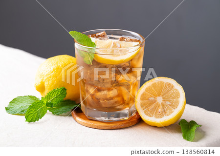 Refreshing iced lemon tea in a glass with sliced lemon and mint leaves 138560814