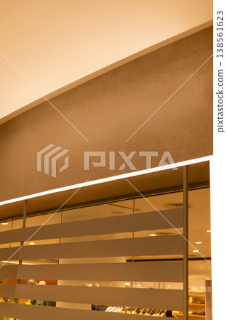 The scene shows an empty storefront with blank space for a logo or sign. The space features clean lines and a modern design, suitable for new retail opportunities 138561623