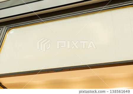 An empty storefront stands ready for branding with a blank area for signage. The glass doors and clean facade offer a space for potential retail activity An empty storefront stands ready for branding with a blank area for signage. The glass doors and clean facade offer a space for potential retail activity 138561649