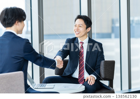 Businessmen conducting business negotiations in an office. Filming assistance provided by: Denpa Gakuen Educational Foundation, Tokyo Electronics College. Businessmen conducting business negotiations in an office. Filming assistance provided by: Denpa Gakuen Educational Foundation, Tokyo Electronics College. 138562130
