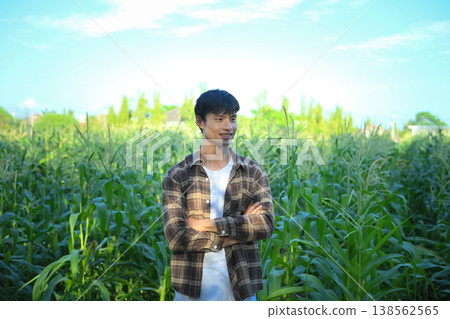 Confident young farmer standing in corn field Confident young farmer standing in corn field 138562565