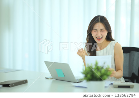 Businesswoman celebrating successful financial results Businesswoman celebrating successful financial results 138562794