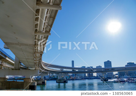 A highway overpass arcs in the backlight. A highway overpass arcs in the backlight. 138563065