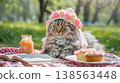 very cute persian cat wearing a pink and white crocheted rose bonnet, sitting on a table with some cakes in front of it, next to an open notebook. 138563448